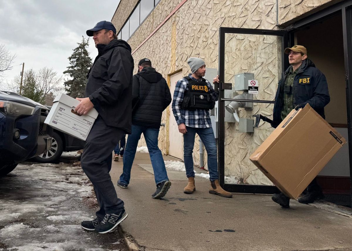 Federal agents load evidence into vans after raiding the office of Ultimate Home Health Services in Bloomington on Thursday, Dec. 18, 2025.