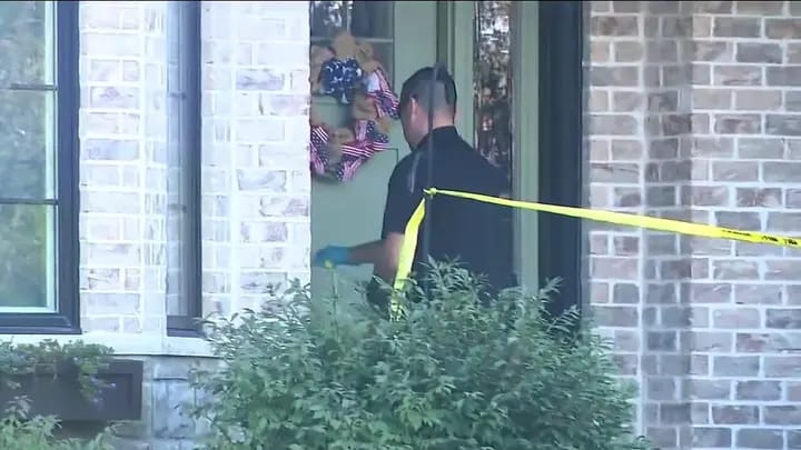 An investigator works behind police tape outside a Frankfort, Ill., home where a 2-year-old boy died.