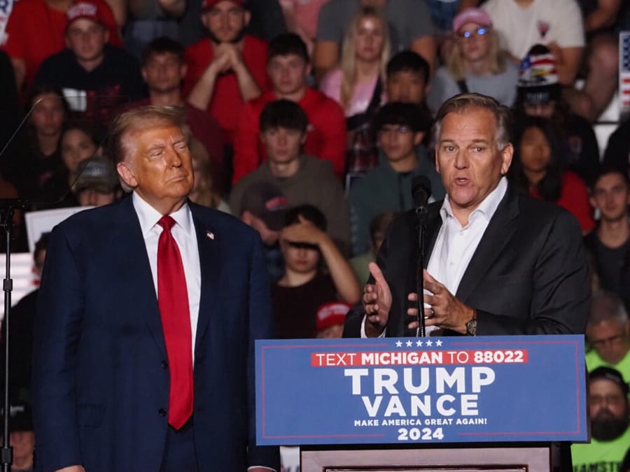 Michigan GOP Senate candidate Mike Rogers (right) speaks at a rally on Saginaw Valley State University campus in Michigan alongside former President Donald Trump (left) on Oct. 3, 2024 ahead of the presidential election