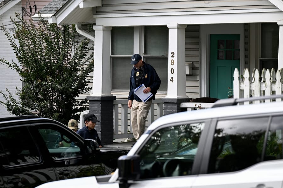 Agents of the Homeland Security Investigations (HSI) work at the entrance of the residence of US Rep. Ilhan Omar (D-MN), after US authorities conducted a raid as part of an ongoing investigation by the Justice Department, in Washington, DC, US, October 12, 2026.